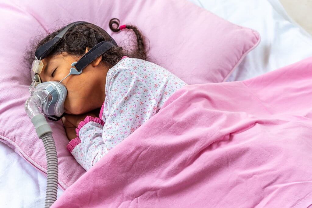 Sleeping child wearing existing stock NIV mask